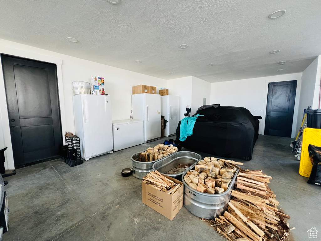 Interior space featuring fridge and freestanding refrigerator