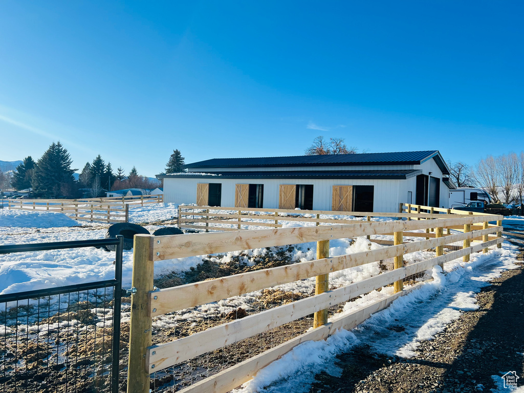 Exterior space featuring an outbuilding, metal roof, and an exterior structure