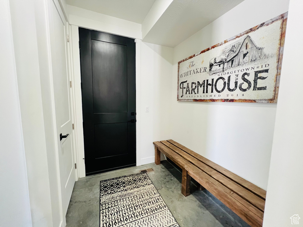 Mudroom featuring unfinished concrete flooring