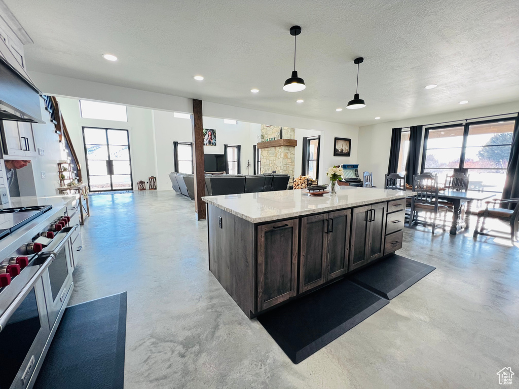 Kitchen with a healthy amount of sunlight, double oven range, and finished concrete flooring