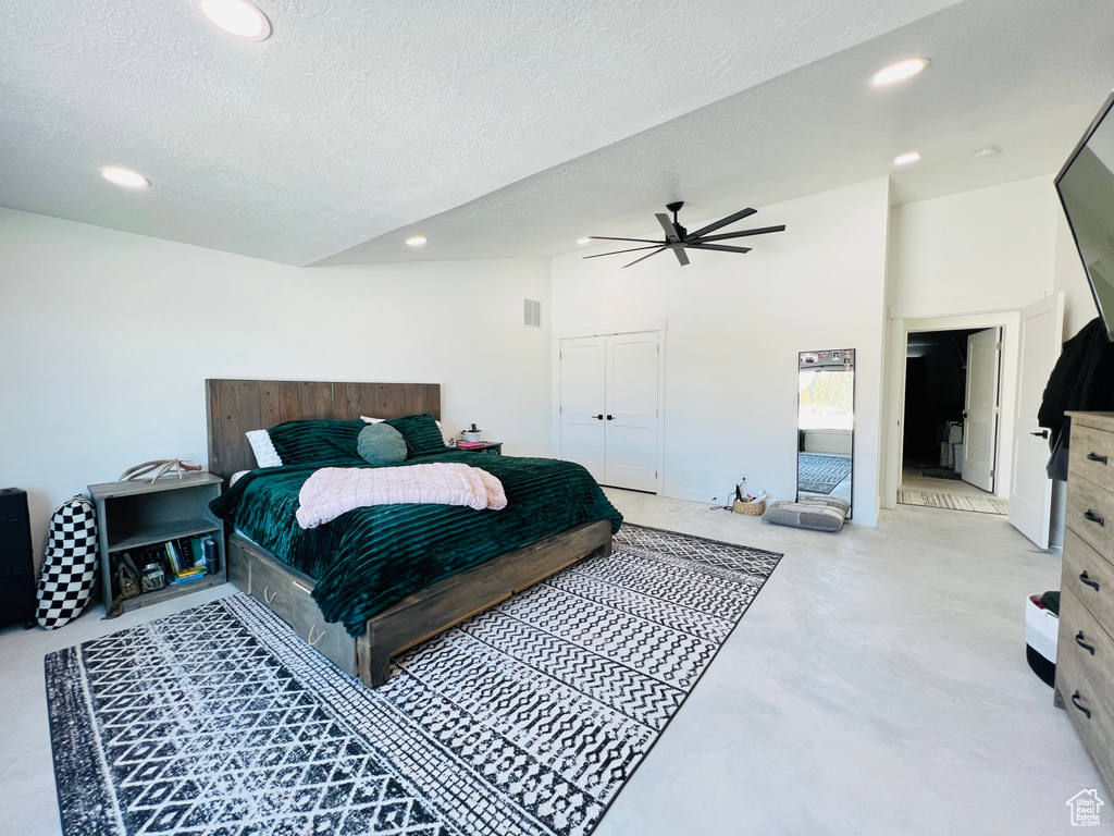 Bedroom featuring concrete flooring, lofted ceiling, ceiling fan, and recessed lighting