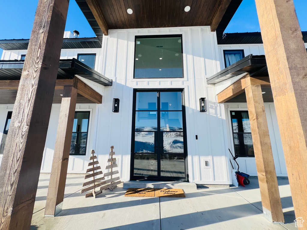 View of exterior entry featuring board and batten siding