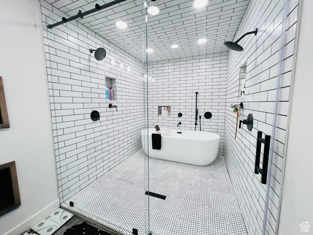 Full bath featuring a shower stall and tile patterned flooring