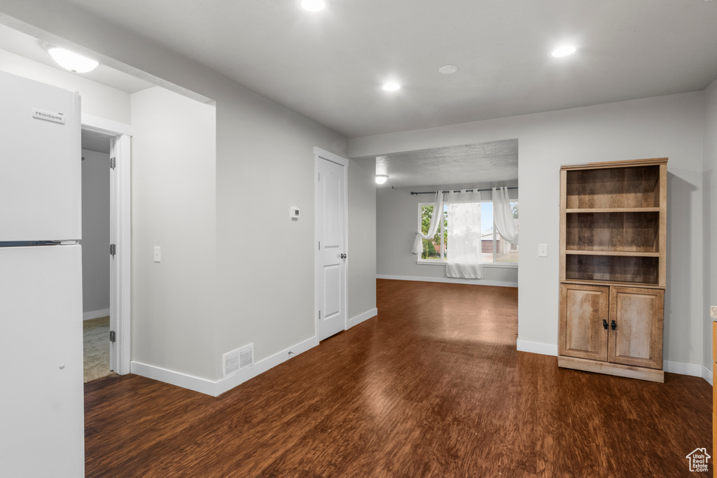 Empty room featuring wood finished floors, recessed lighting, and baseboards