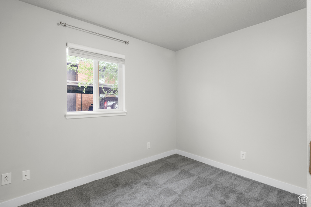 Empty room featuring carpet floors and baseboards