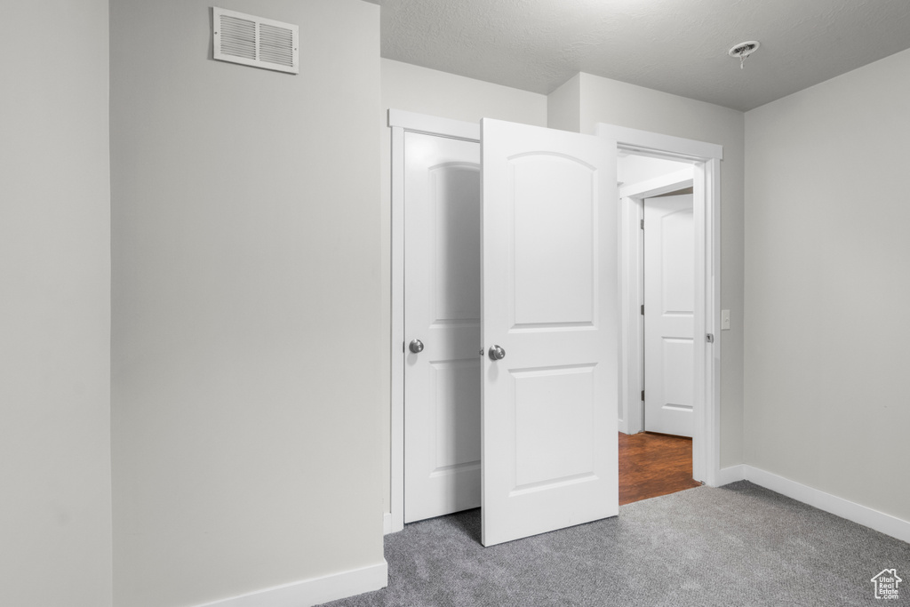 Unfurnished bedroom with carpet and baseboards