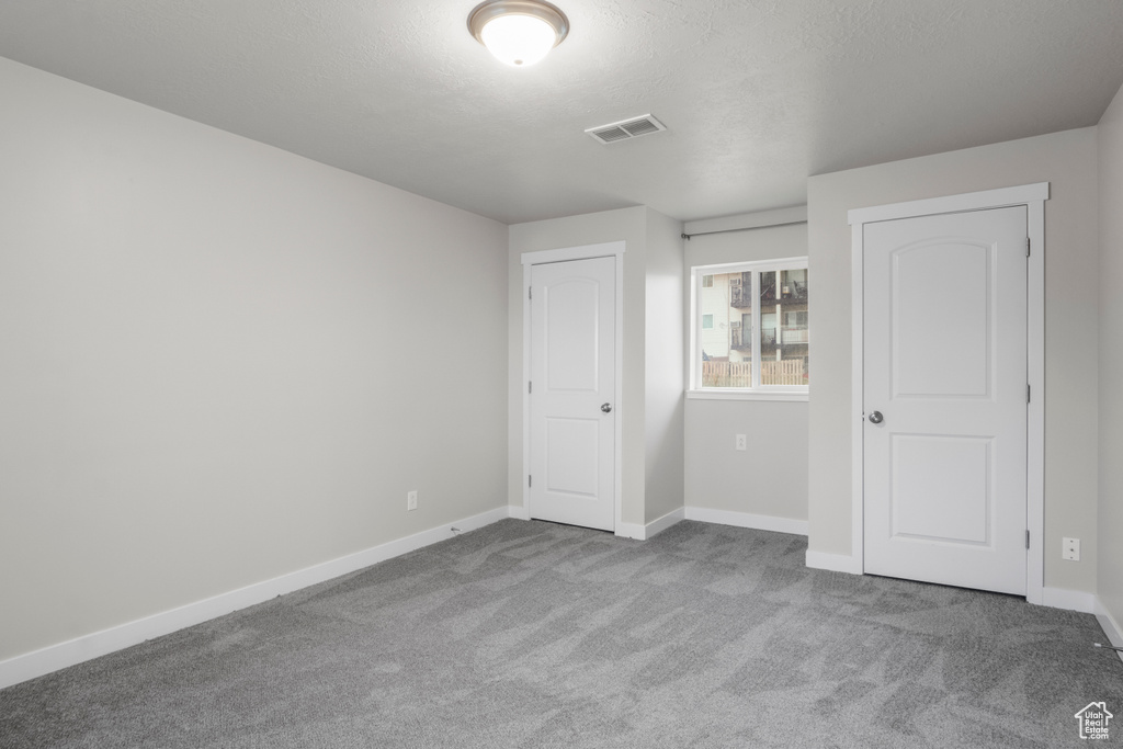 Unfurnished bedroom with carpet floors and baseboards