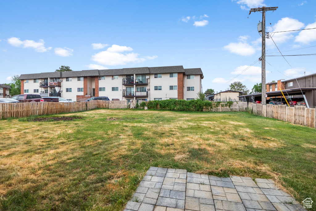 View of yard with fence and a residential view