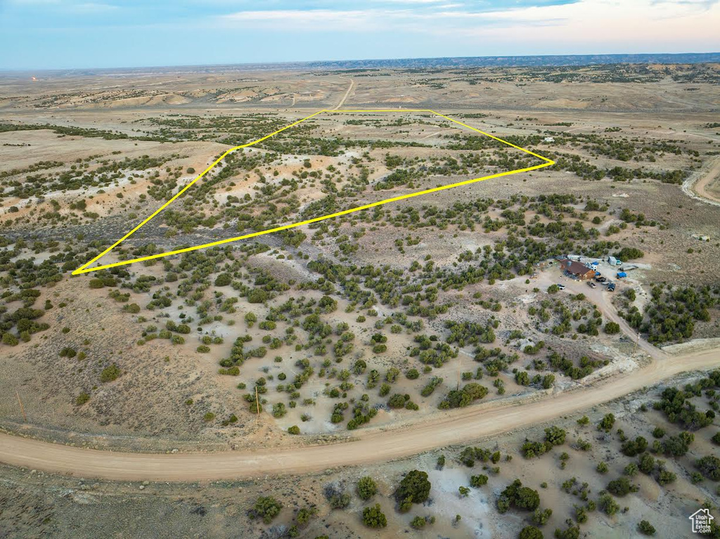 Birds eye view of property featuring a desert view and a rural view
