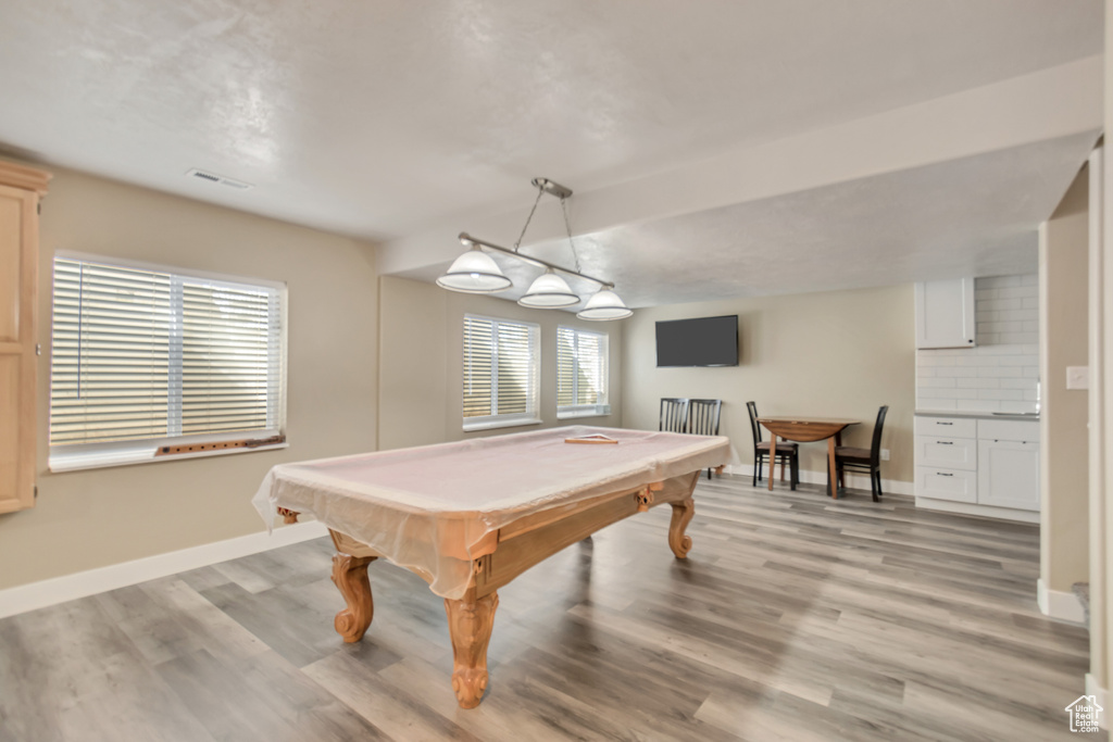 Rec room with light wood-style floors, visible vents, billiards, and baseboards