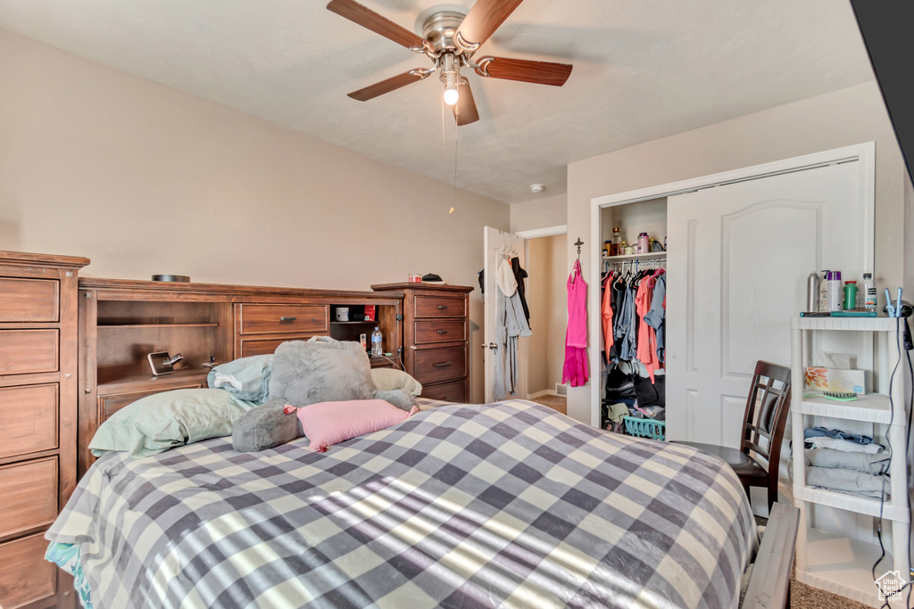 Bedroom featuring a ceiling fan and a closet