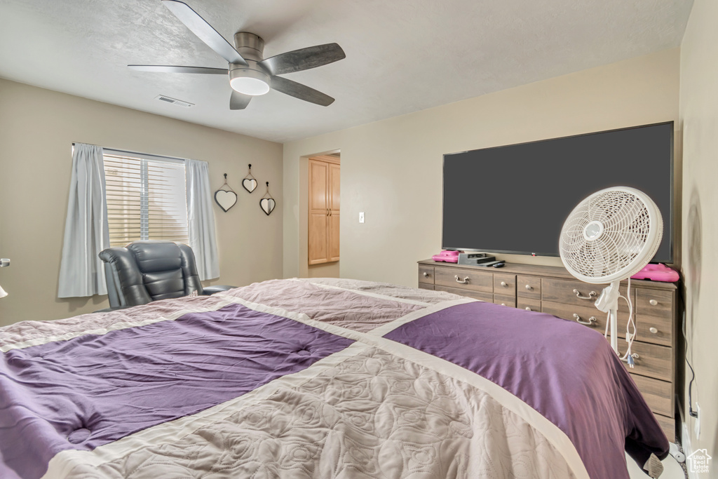 Bedroom with visible vents and a ceiling fan