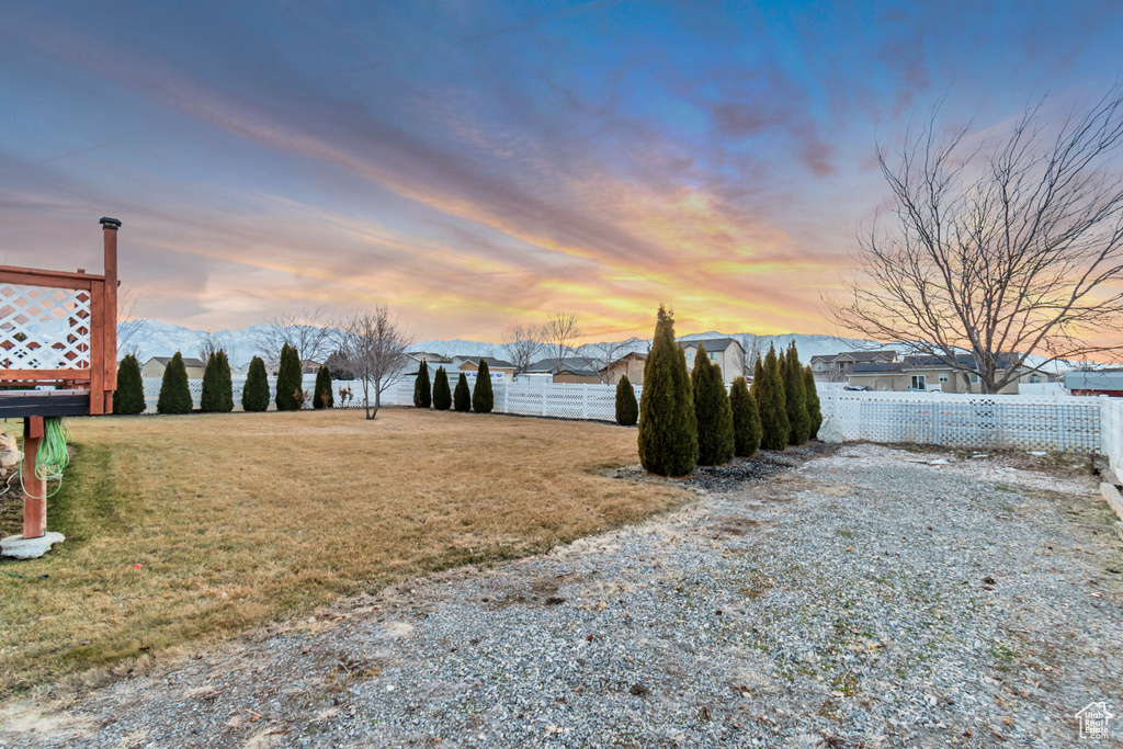 View of yard with fence and a mountain view