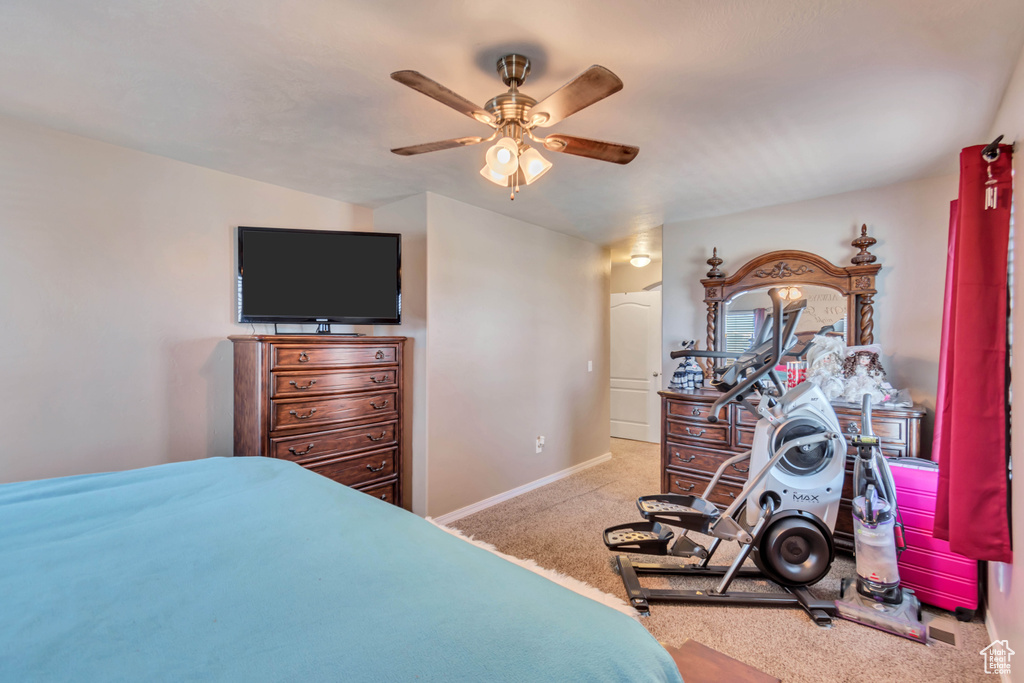 Bedroom featuring a ceiling fan, carpet, and baseboards