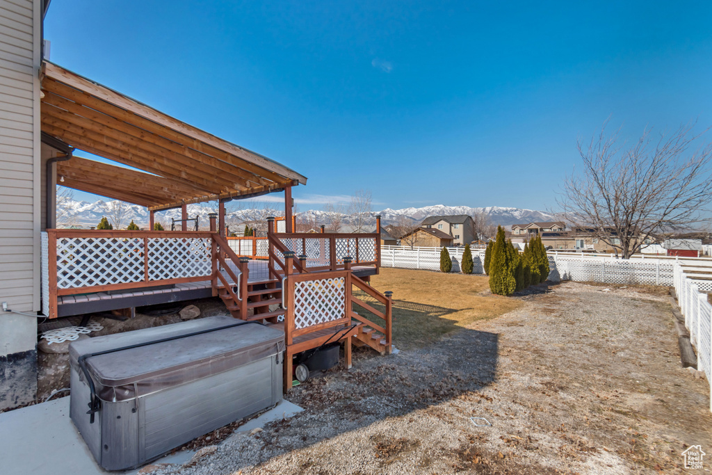 View of yard with a deck with mountain view and a fenced backyard