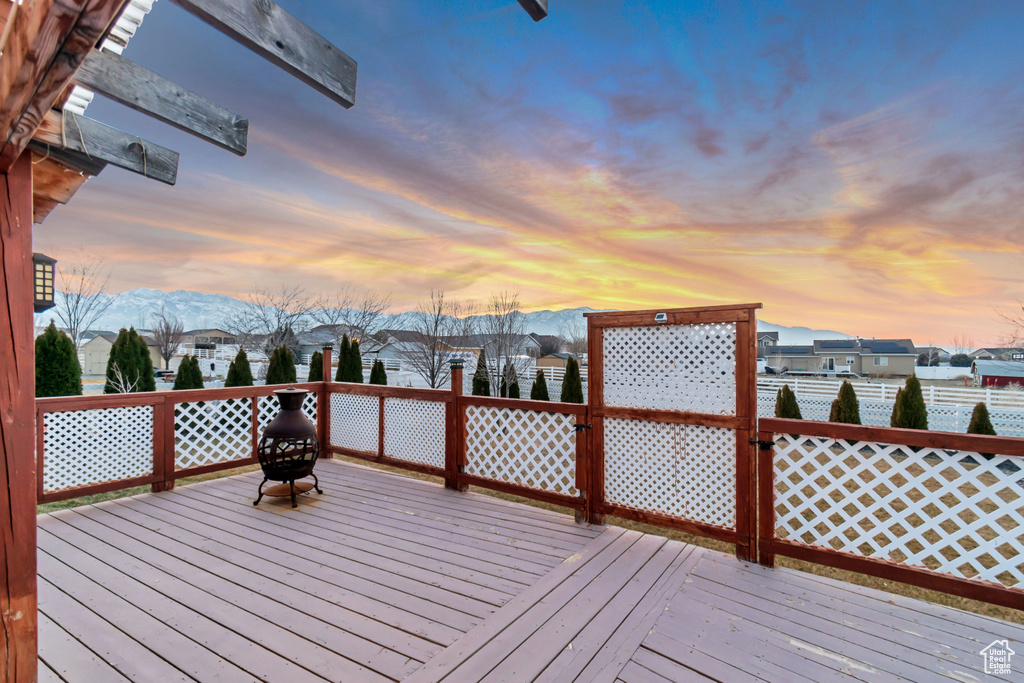 Wooden deck featuring a residential view and a mountain view