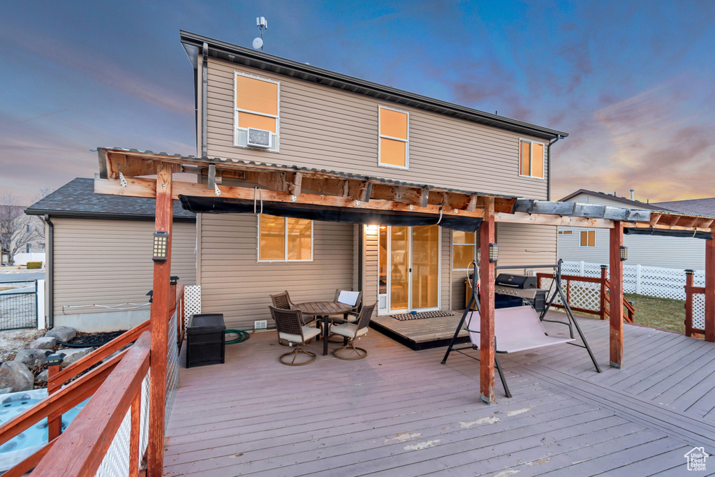 Wooden deck featuring fence and cooling unit