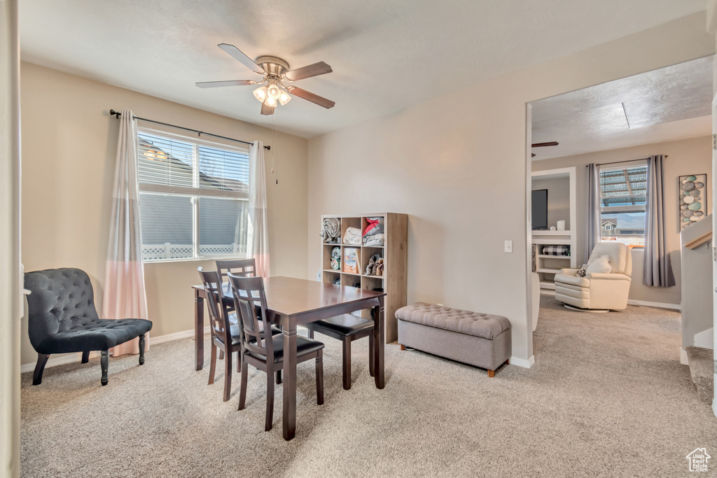 Dining space with carpet, baseboards, and ceiling fan