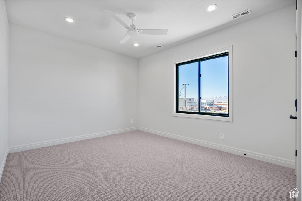 Spare room with recessed lighting, visible vents, light carpet, ceiling fan, and baseboards