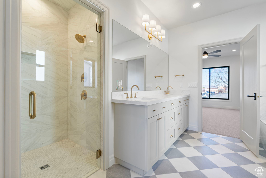 Full bath featuring a stall shower, double vanity, a sink, and tile patterned floors