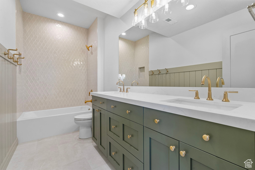 Full bathroom with double vanity, visible vents, shower / washtub combination, and a sink