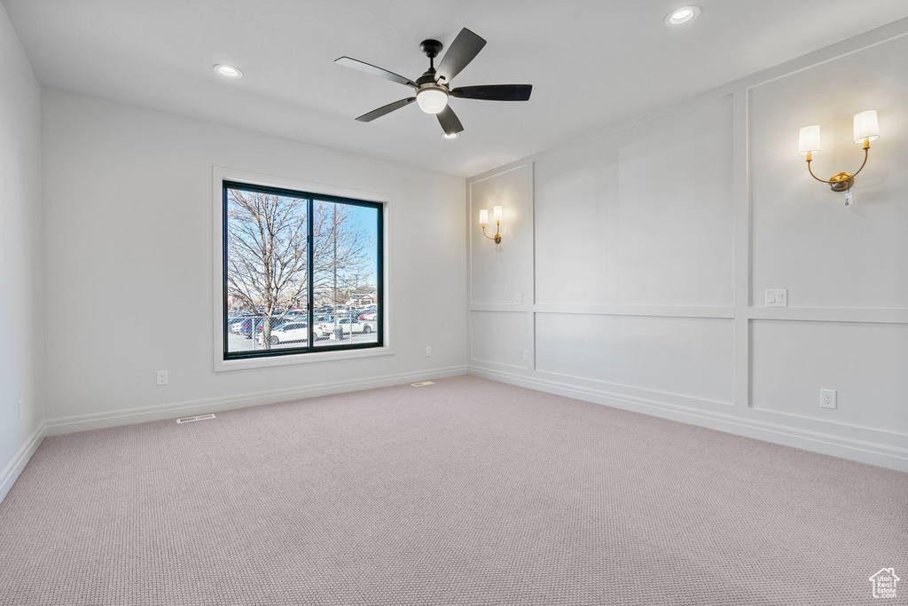 Empty room featuring ceiling fan, recessed lighting, baseboards, and light colored carpet