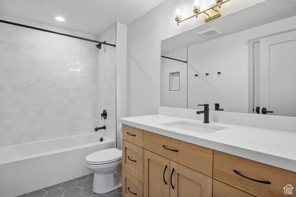 Full bath with visible vents, toilet, tile patterned floors, tub / shower combination, and vanity