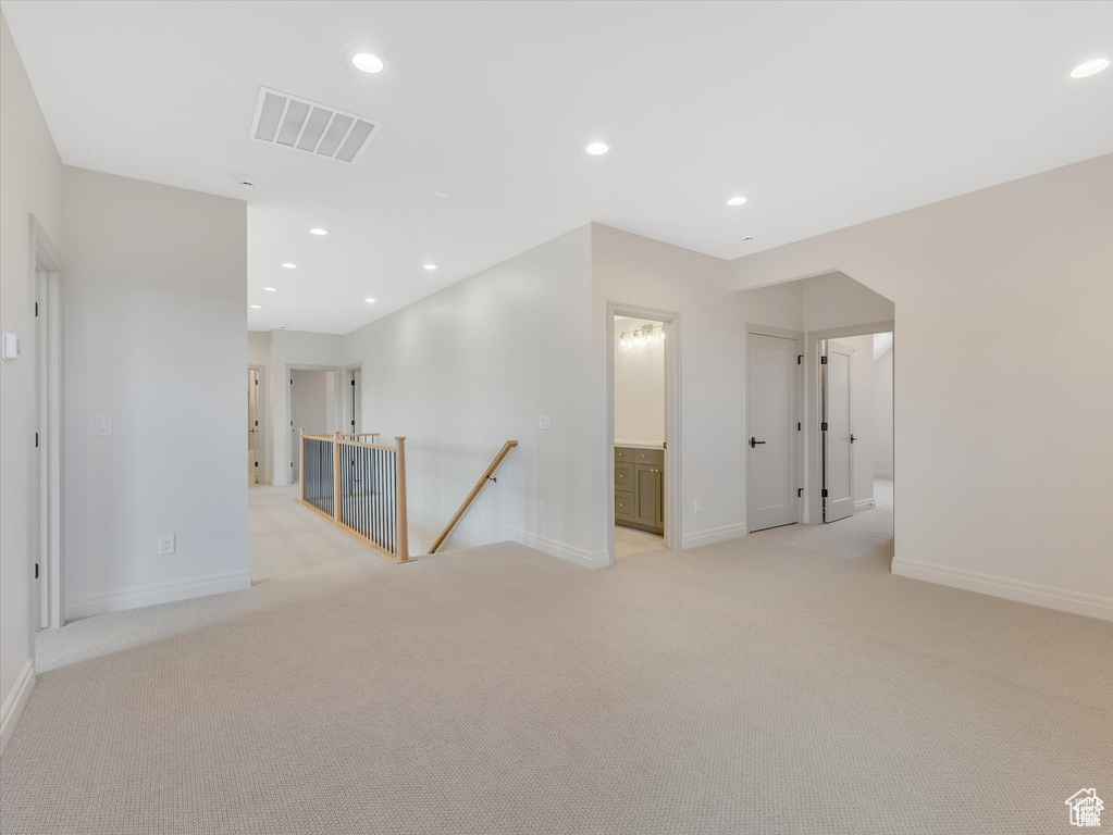 Unfurnished room with light colored carpet, visible vents, baseboards, and recessed lighting