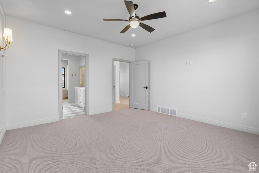 Unfurnished bedroom with light colored carpet, visible vents, baseboards, and recessed lighting