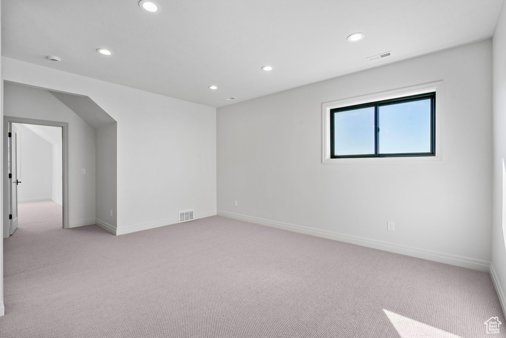 Spare room featuring baseboards, light colored carpet, visible vents, and recessed lighting