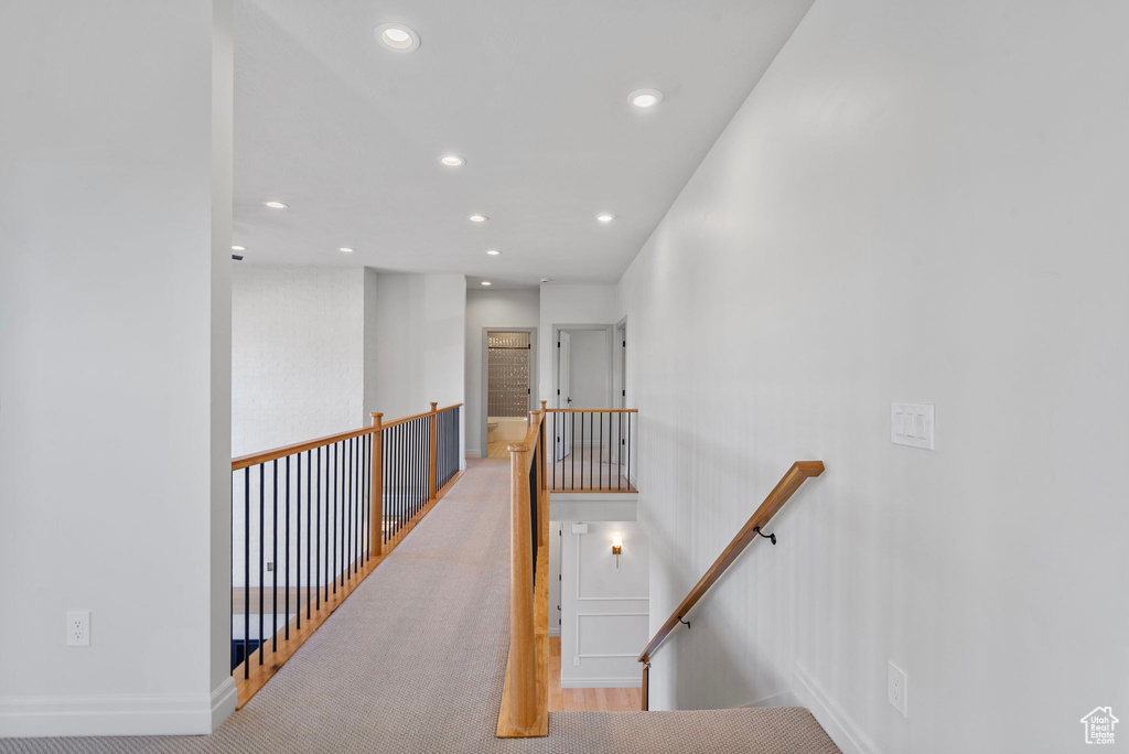 Hall featuring recessed lighting, baseboards, and an upstairs landing