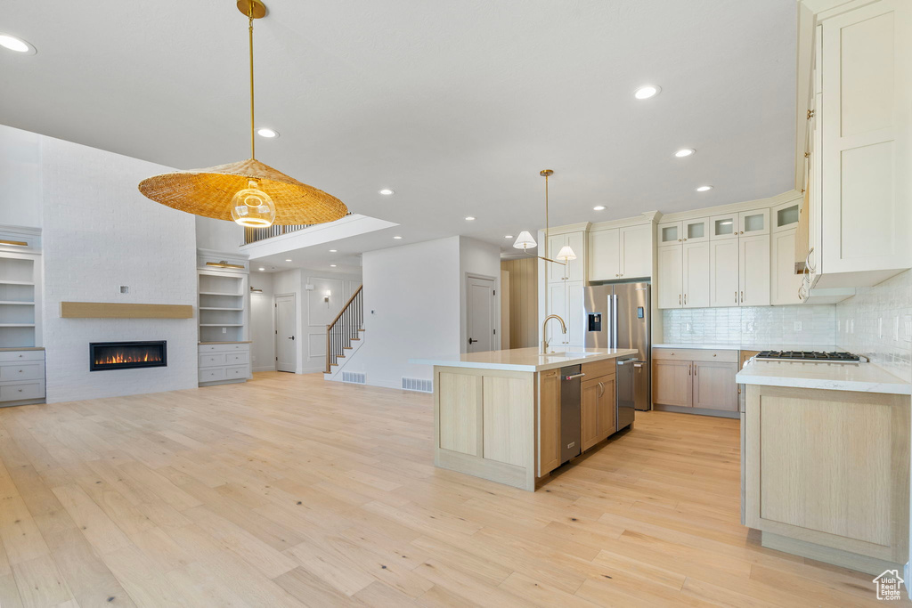 Kitchen featuring stainless steel appliances, light wood-type flooring, and light countertops