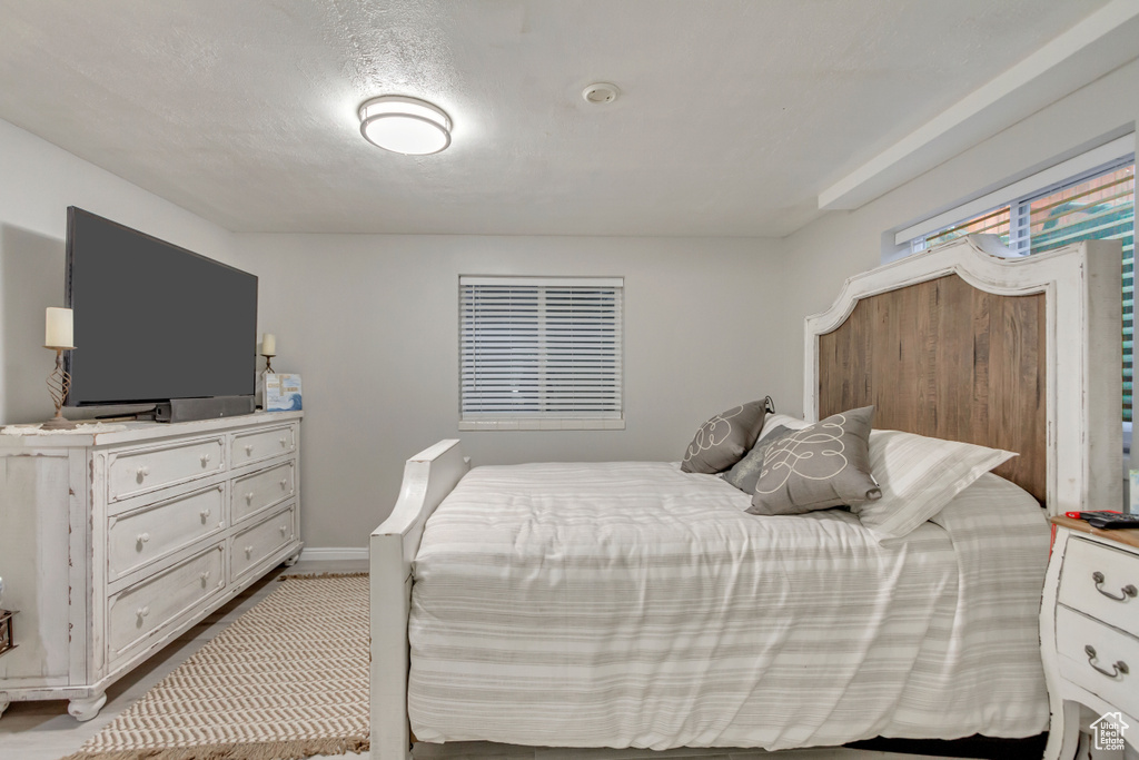 Bedroom featuring light wood-style floors and baseboards