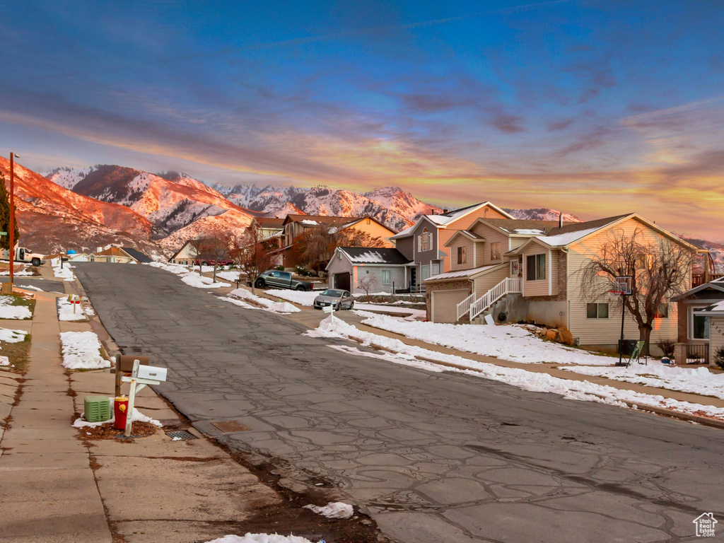 View of road featuring sidewalks, a residential view, and a mountain view