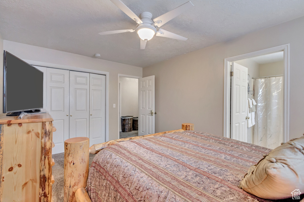 Carpeted bedroom featuring a closet, ceiling fan, and a textured ceiling