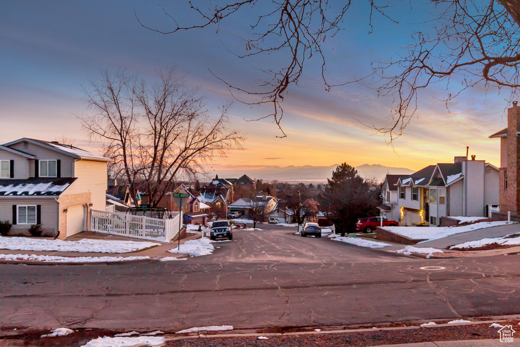 View of road with a residential view, curbs, and sidewalks