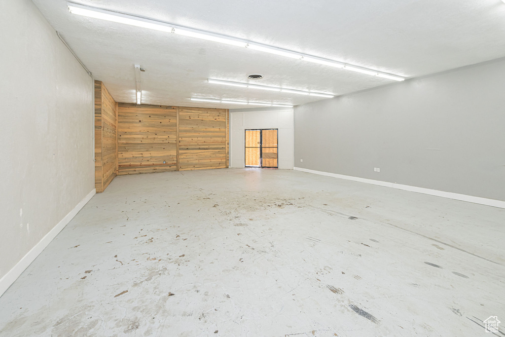 Empty room featuring concrete floors and baseboards