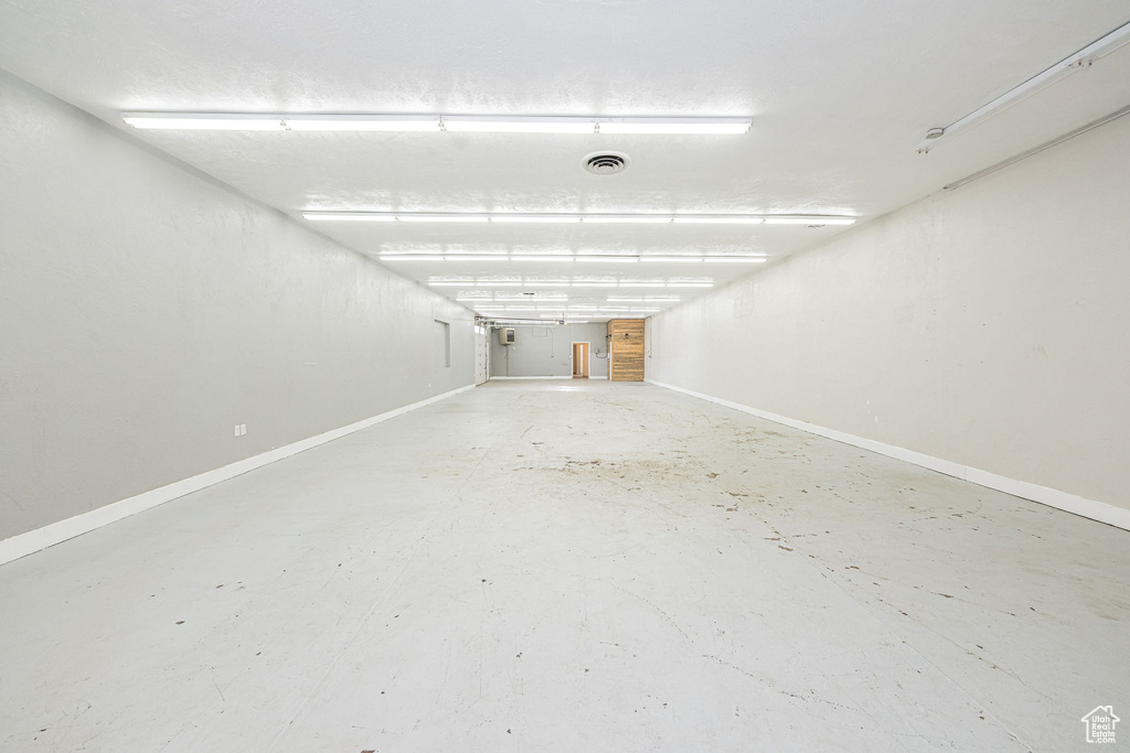 Parking garage featuring visible vents and baseboards