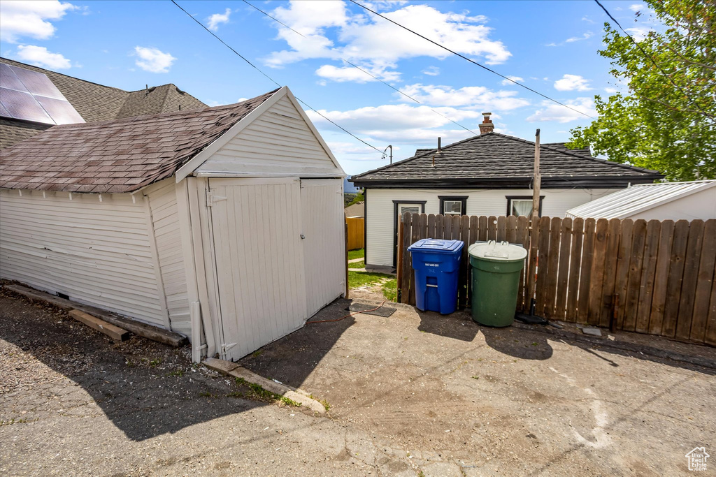 View of shed featuring fence