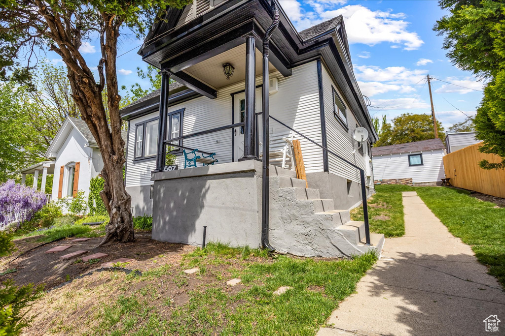 View of property exterior featuring fence