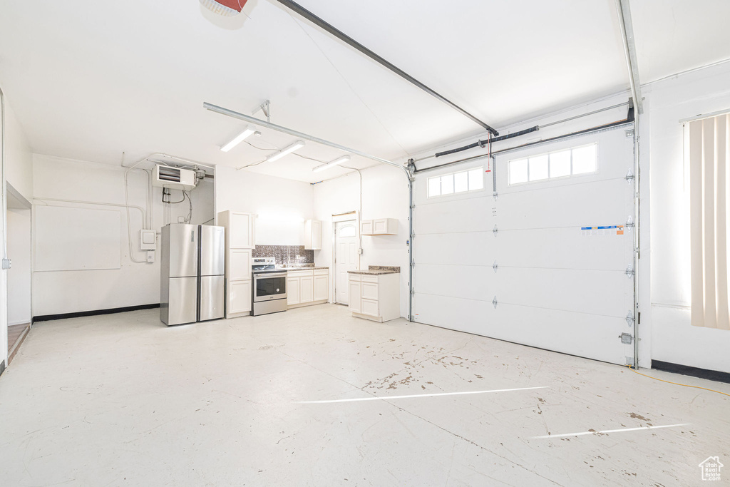 Garage featuring freestanding refrigerator