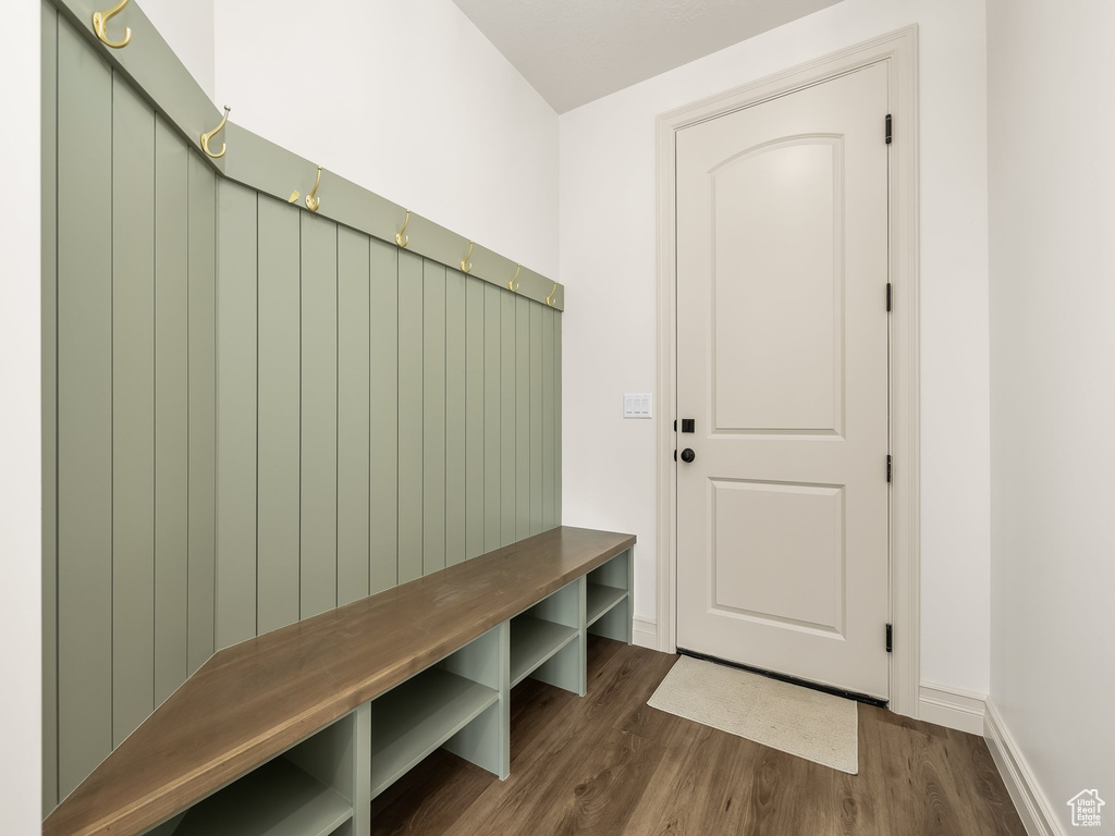 Mudroom with wood finished floors and baseboards