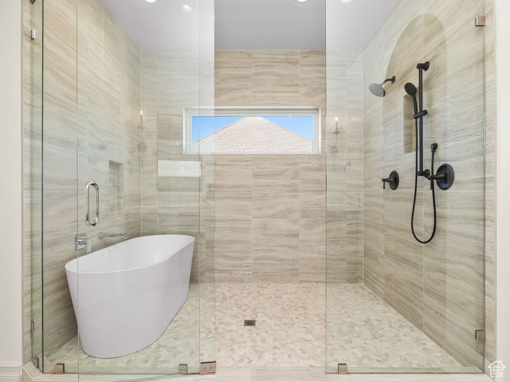 Bathroom featuring a freestanding bath and a stall shower