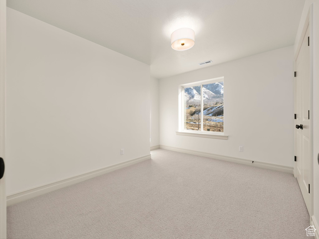 Unfurnished bedroom with carpet, visible vents, and baseboards