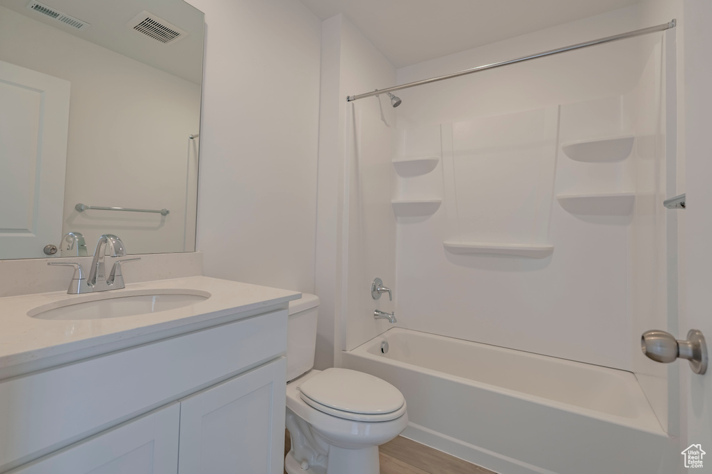 Full bath featuring vanity, bathing tub / shower combination, toilet, and visible vents