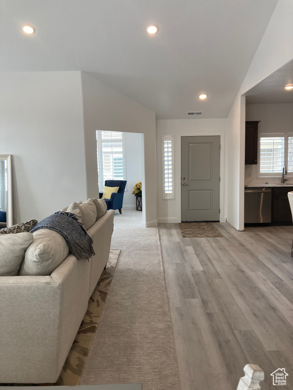 Foyer with recessed lighting, visible vents, vaulted ceiling, and light wood-style flooring