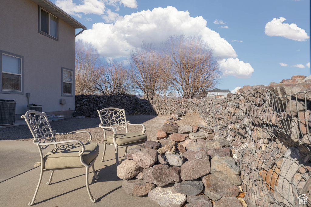 View of patio with fence and central AC