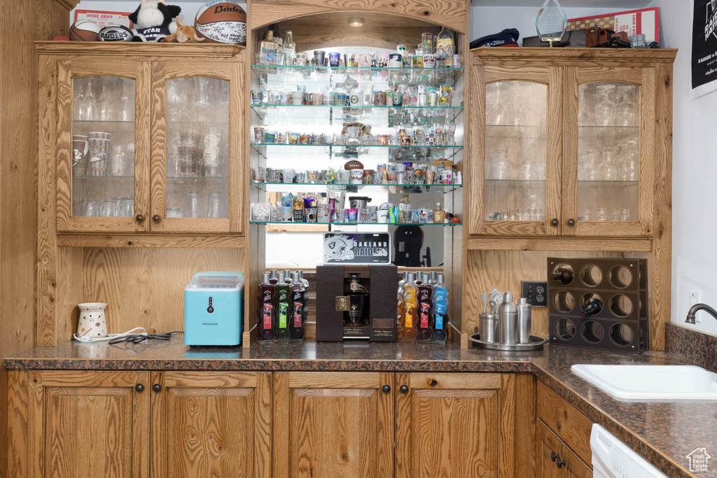 Bar with a bar, white dishwasher, and a sink