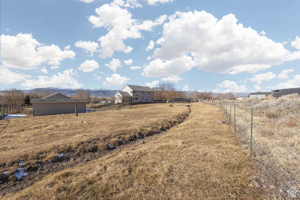 View of yard featuring fence and a rural view