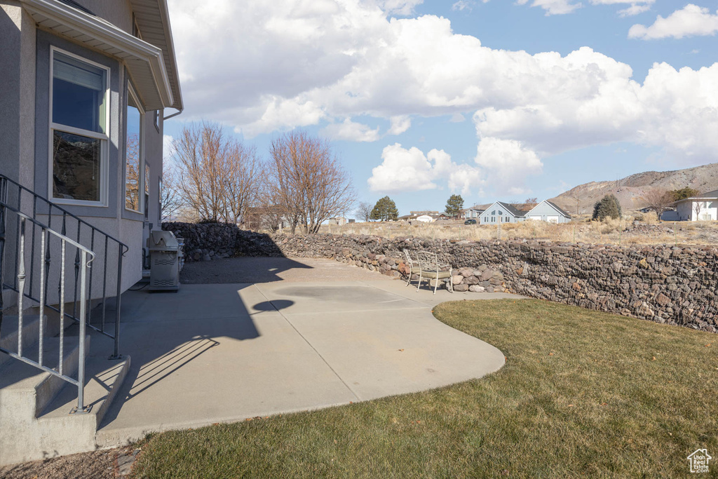 View of yard with a mountain view and a patio